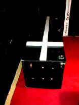 A modern coffin with a Christian cross on the lid.