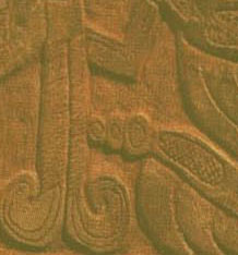 A cutout from the panel of the serpent's tail with rattles